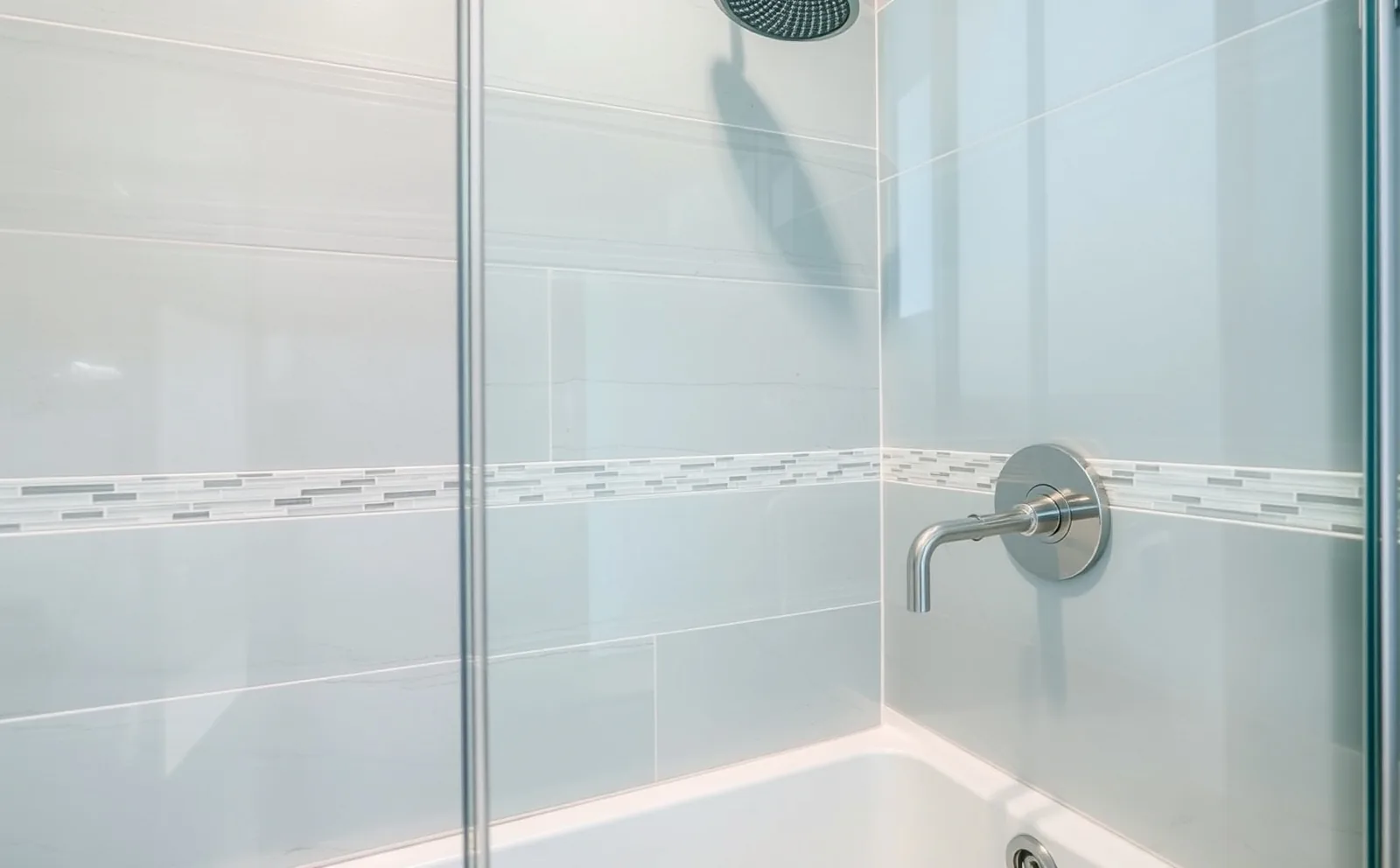 Custom tile and frameless glass in an Aventura remodel Haven bathrooms in Aventura, FL — Schluter waterproofing membrane applied to shower walls before tiling