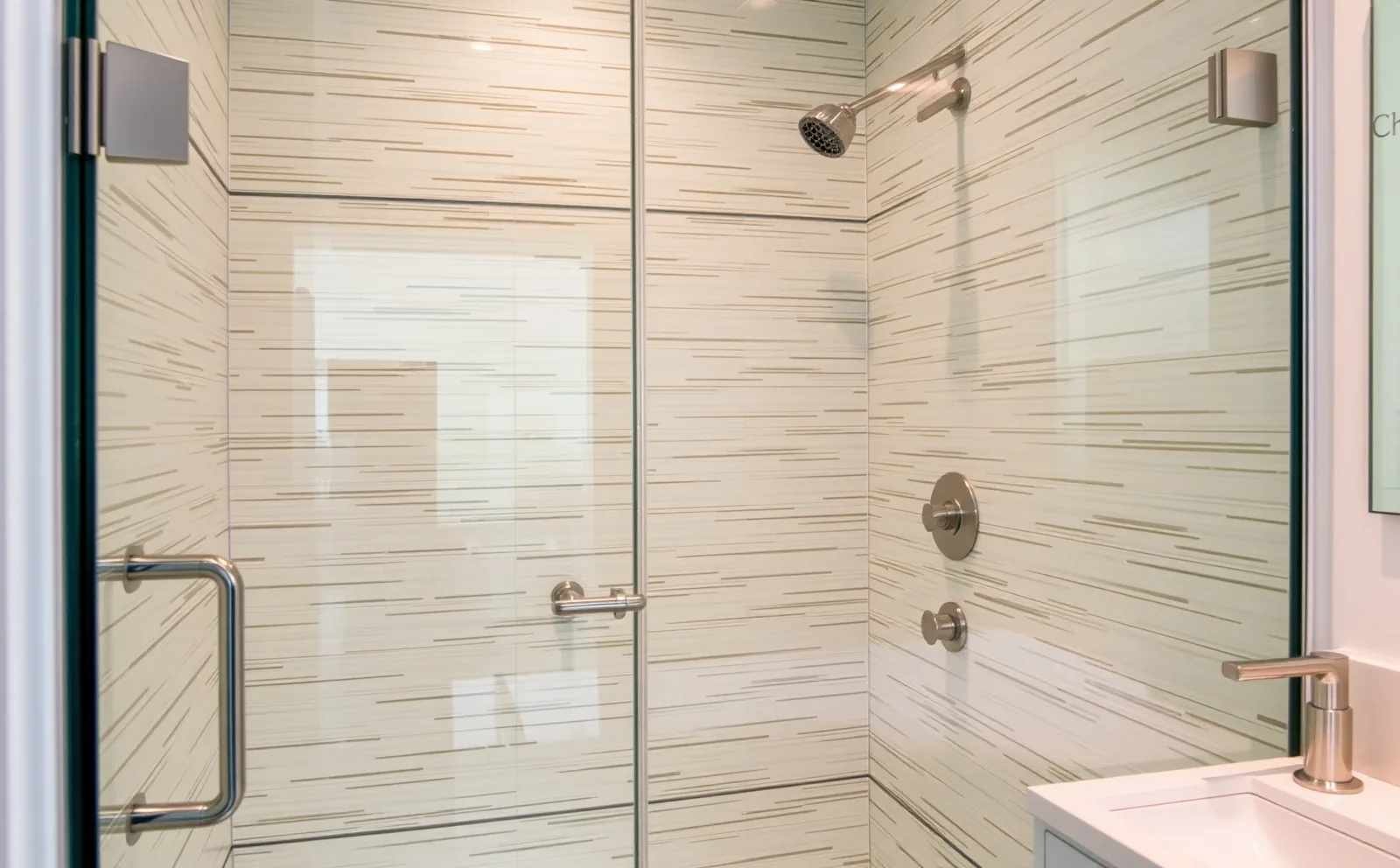 A Haven-installed curbless walk-in shower with frameless glass and large-format tile — the kind of refined detail that fits naturally in a Coral Gables home. Haven bathrooms in Coral Gables, FL — Schluter waterproofing membrane applied to shower walls before tiling