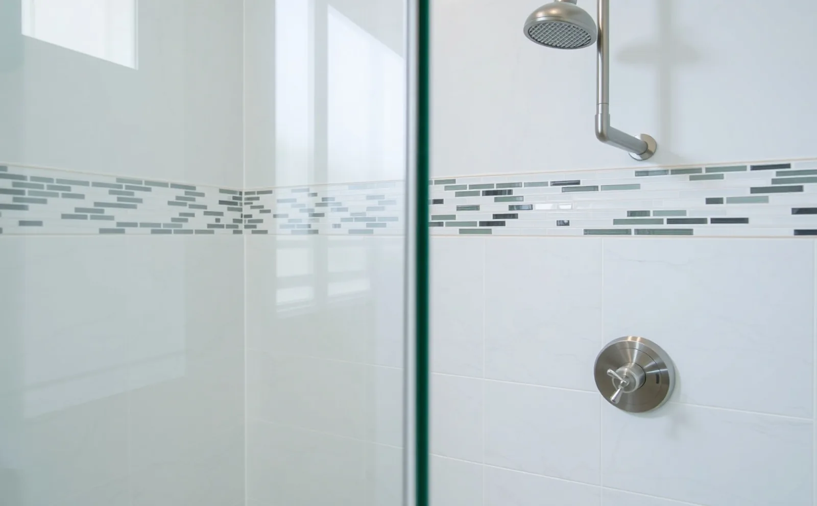 Custom tile and frameless glass — a Haven walk-in shower in Doral Haven bathrooms in Doral, FL — Schluter waterproofing membrane applied to shower walls before tiling