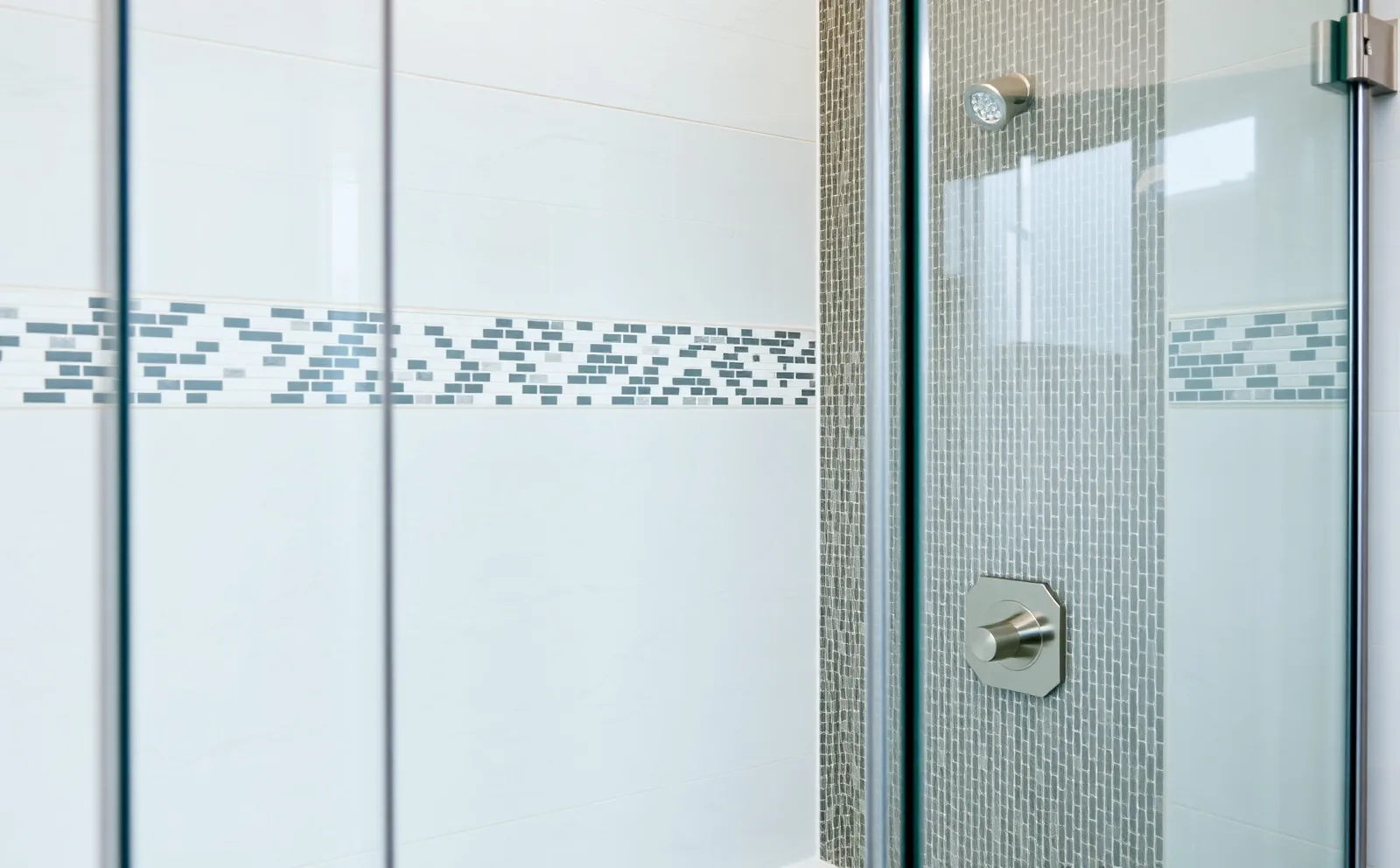 A Haven-installed curbless walk-in shower in a Hialeah home — large-format tile, frameless glass, and a ceiling rainfall head complete the design. Haven bathrooms in Hialeah, FL — Schluter waterproofing membrane applied to shower walls before tiling