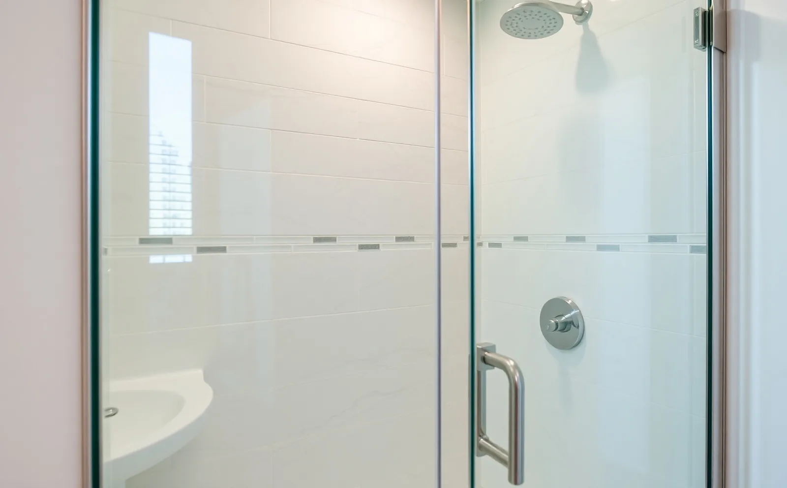 A Haven-installed curbless walk-in shower in North Miami featuring large-format porcelain tile, frameless glass, and a linear drain — built for South Florida's coastal climate. Bathroom Remodeling in North Miami, FL — mid 1 photo by Haven in North Miami, FL